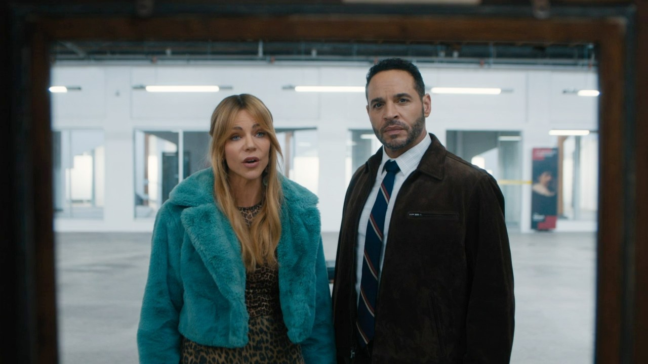 Daniel Sunjata and Kaitlin Olson looking ahead and talking in High Potential.