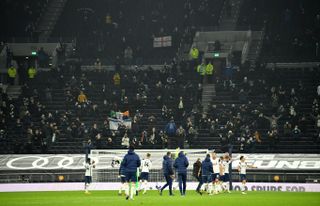 Tottenham players applaud the 2,000 fans who were in the stadium to watch their victory