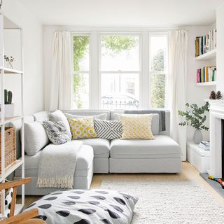 white living room with sofa and window