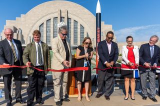 Neil Armstrong's sons, Mark and Rick (second and third from left) help cut the ribbon opening the "Destination Moon: The Apollo 11 Mission" exhibition outside the Cincinnati Museum Center's Union Terminal in Ohio on Saturday, Sept. 28, 2019.