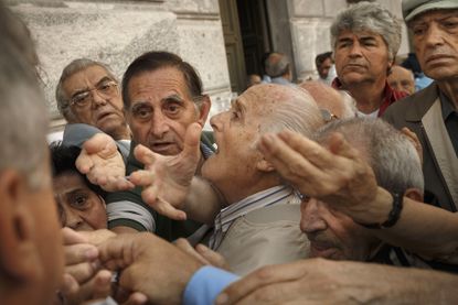 Greek pensioners try to get into a bank in Athens.