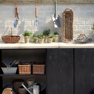 potting table with plants and garden tools