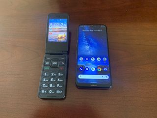 A Cingular Flip IV next to a Nokia G20
