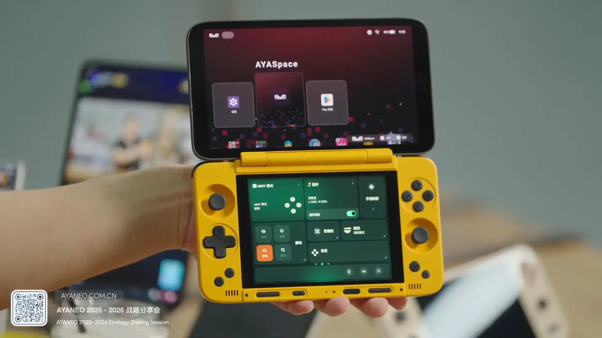 Close up of hand holding yellow Ayaneo Pocket DS with the display fully open and Ayaspace on screen.