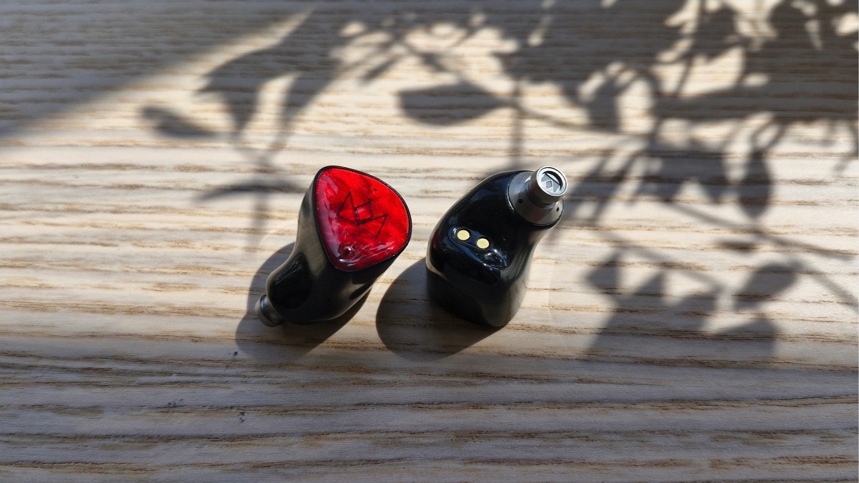 Noble FoKus Amadeus in-ear headphones on a wooden surface