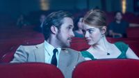La La Land still. Mia and Sebastian gaze at each other in a cinema.