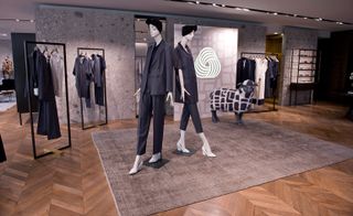 Interior view of Max Mara boutique showing clothing range and a statue of a sheep