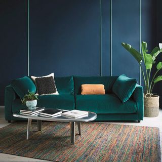 living area with green velvet sofa set