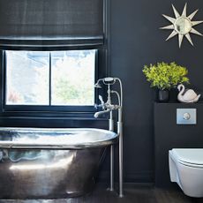 Black bathroom with metal bathtub