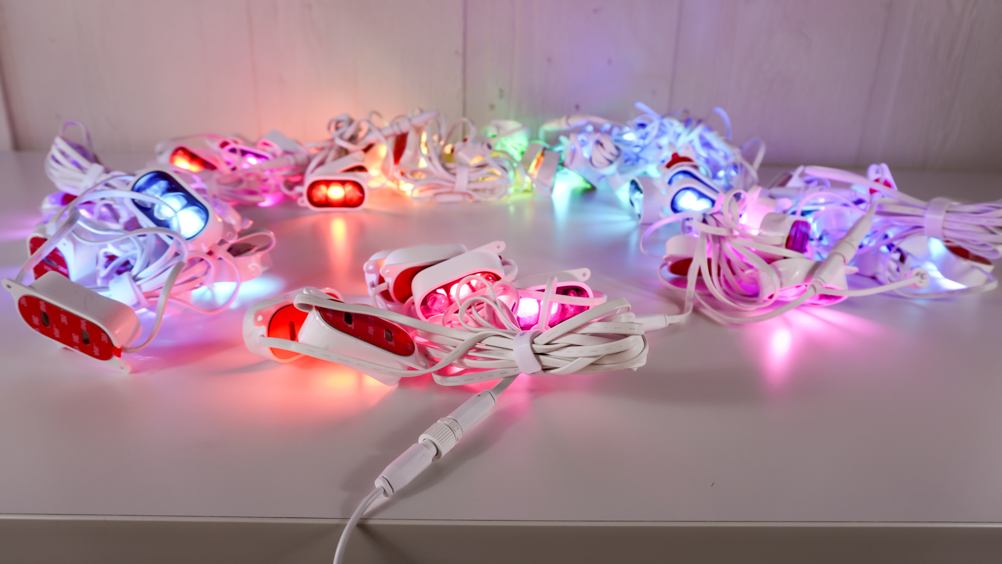 Multiple strands of Govee&#039;s Prism permanent outdoor lights connected together and lit up on a table