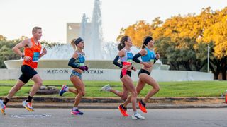 Runners in the 2022 Chevron Houston Marathon pass the Mecom Fountain