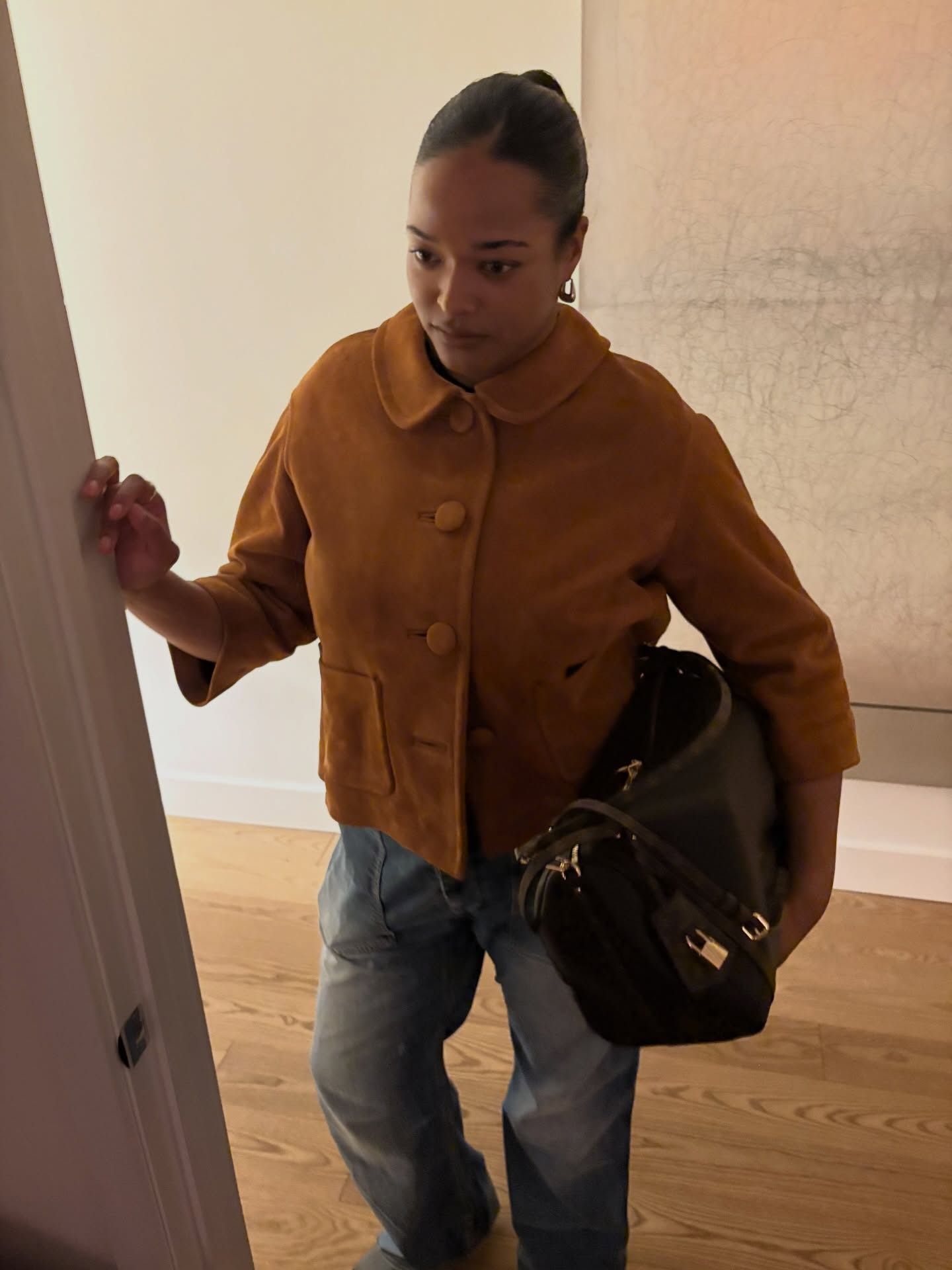 Woman showing how to wear a clutch this fall.