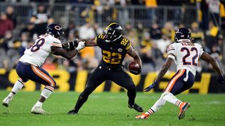 Running back Najee Harris #22 of the Pittsburgh Steelers pushes off cornerback Kindle Vildor #22 and inside linebacker Roquan Smith #58 of the Chicago Bears as he carries the ball down the field during the second half at Heinz Field on Nov. 8, 2021 in Pittsburgh, Pennsylvania.