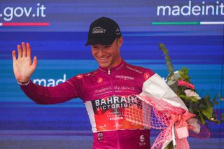 Bahrain Victoriouss Italian rider Jonathan Milan celebrates his best sprinters cyclamen jersey on the podium after the twelfth stage of the Giro dItalia 2023 cycling race 179 km between Bra and Rivoli on May 18 2023 Photo by Luca Bettini AFP Photo by LUCA BETTINIAFP via Getty Images