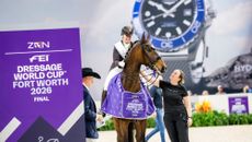 British dressage rider Becky Moody sitting on her horse, Jagerbomb, with her groom, Kim Masson, standing by her side during the prizegiving at the 2026 World Cup Final in Fort Worth, Texas.
