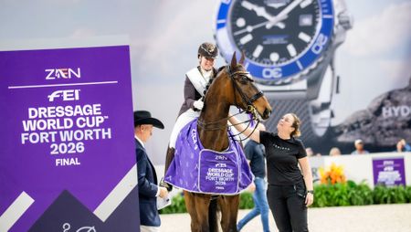 British dressage rider Becky Moody sitting on her horse, Jagerbomb, with her groom, Kim Masson, standing by her side during the prizegiving at the 2026 World Cup Final in Fort Worth, Texas.