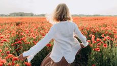 Woman dancing in poppy field
