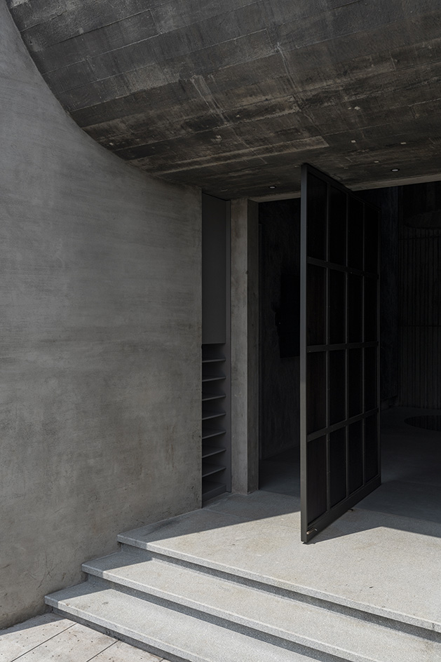 Brutalist mosque in Kerala, concrete structure moody entrance