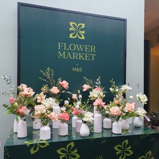 Large M&S Flower Market logo with bud vases of fresh flowers underneath