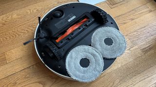 Xiaomi X20 Pro robot vacuum flipped over to show mop pads and brushroll