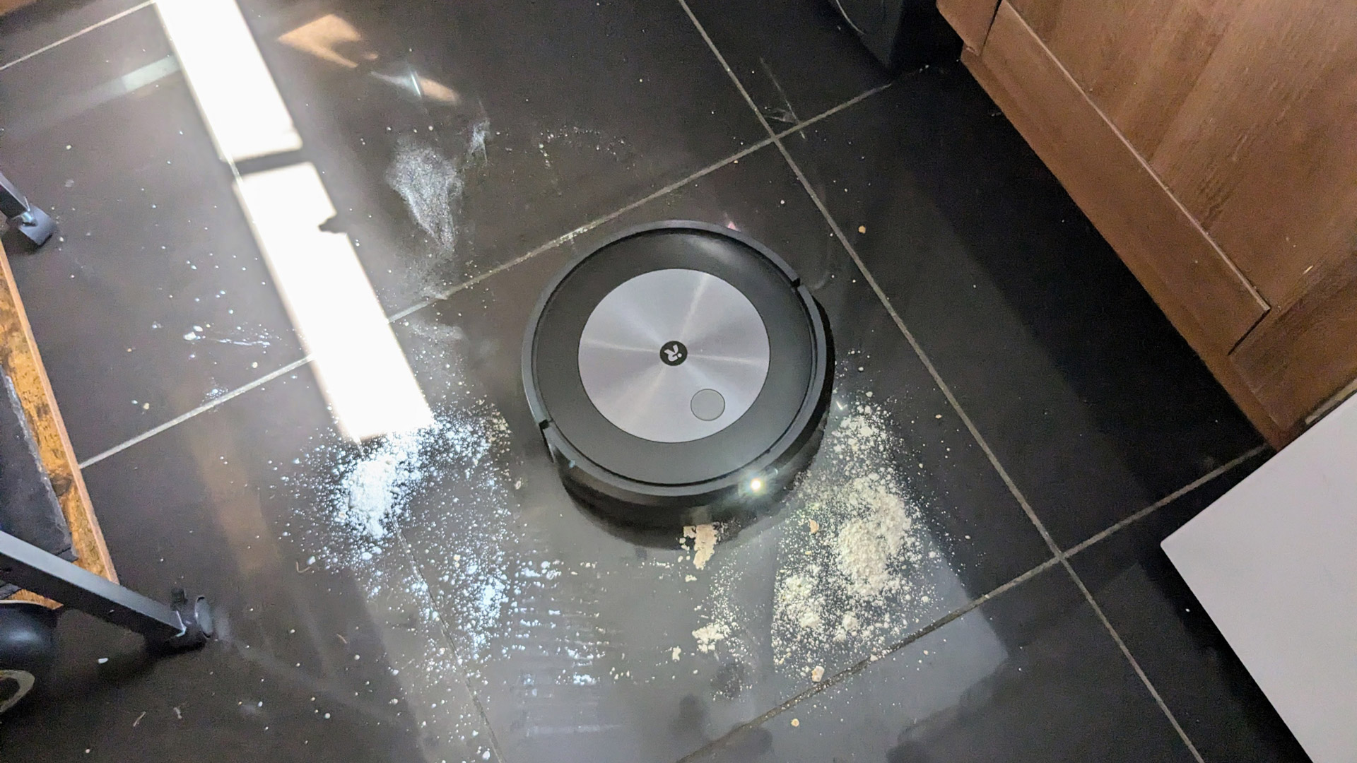 iRobot Roomba Combo j5+ cleaning flour off a kitchen floor