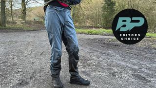 Lower half of man wearing waterproof cycling trousers
