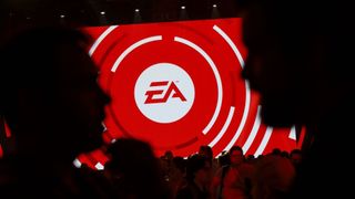 Attendees gather in front of an Electronic Arts Inc. (EA) logo displayed on a screen during the company's EA Play event ahead of the E3 Electronic Entertainment Expo in Los Angeles, California, U.S., on Saturday, June 10, 2017. EA revealed two new titles along with the annual iterations of the company's sports games, as well as unveiling the highly anticipated "Star Wars: Battlefront II" open-world multiplayer gameplay. Photographer: Patrick T. Fallon/Bloomberg via Getty Images