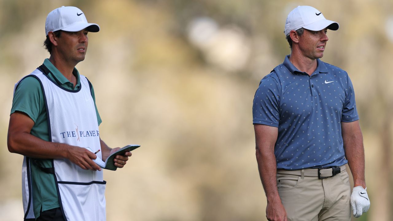 Photo of Rory Mcilroy and his caddy