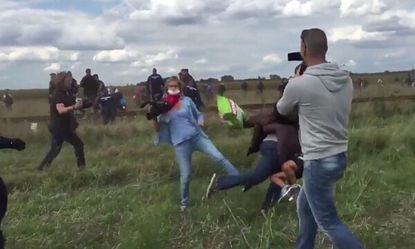 A still from the video showing Petra László kicking refugees.