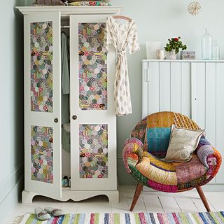white country style bedroom with patchwork wardrobe and textile chair