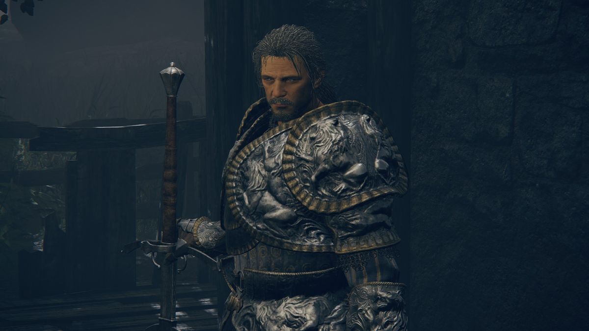 Elden Ring - Bernahl standing in the warmaster's shack holding a sword