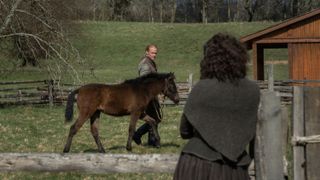 Jamie Fraser walking with a horse in Outlander season 7 episode 2