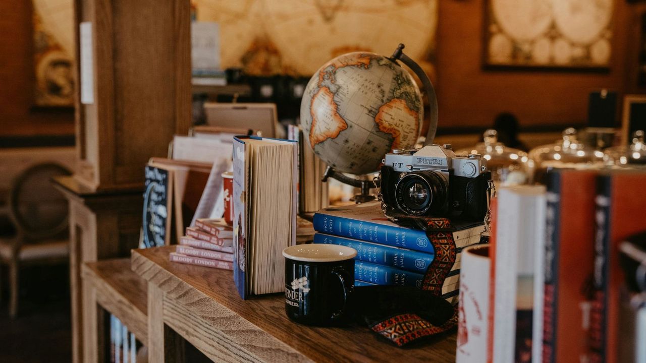 A close-up on a vintage sale stall selling vintage books and globes