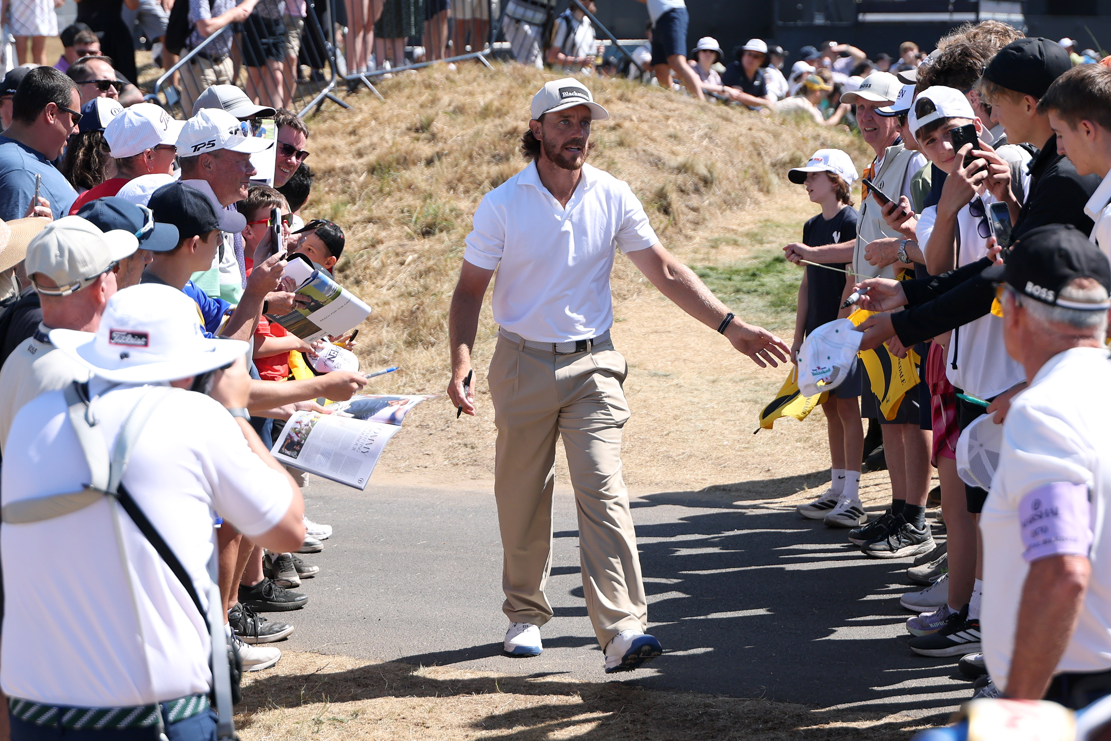 Tommy Fleetwood of England interacts with fans on the 10th hole during a practice round, prior to The 154th Open Championship at Royal Birkdale (Photo by Andrew Redington/Getty Images)