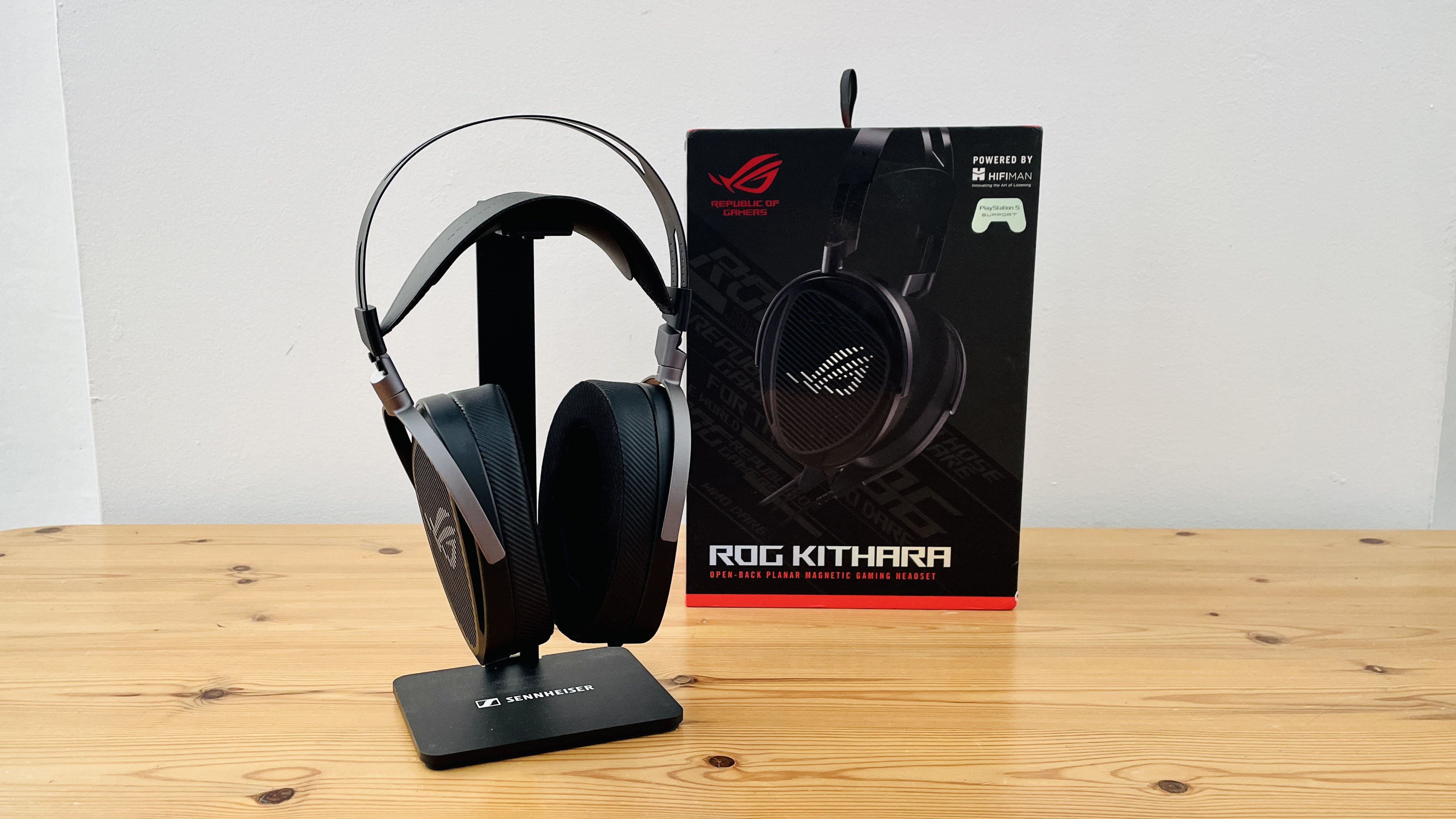 A picture of the Asus ROG Kithara audiophile wired gaming headset on a wooden surface.