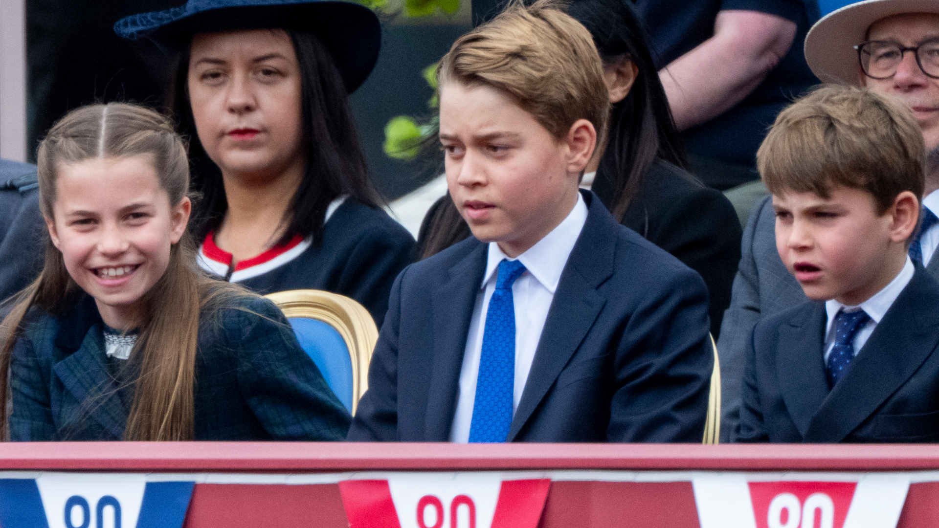 Princess Charlotte, Prince George and Prince Louis sitting next to each other at the VE Day 80 parade