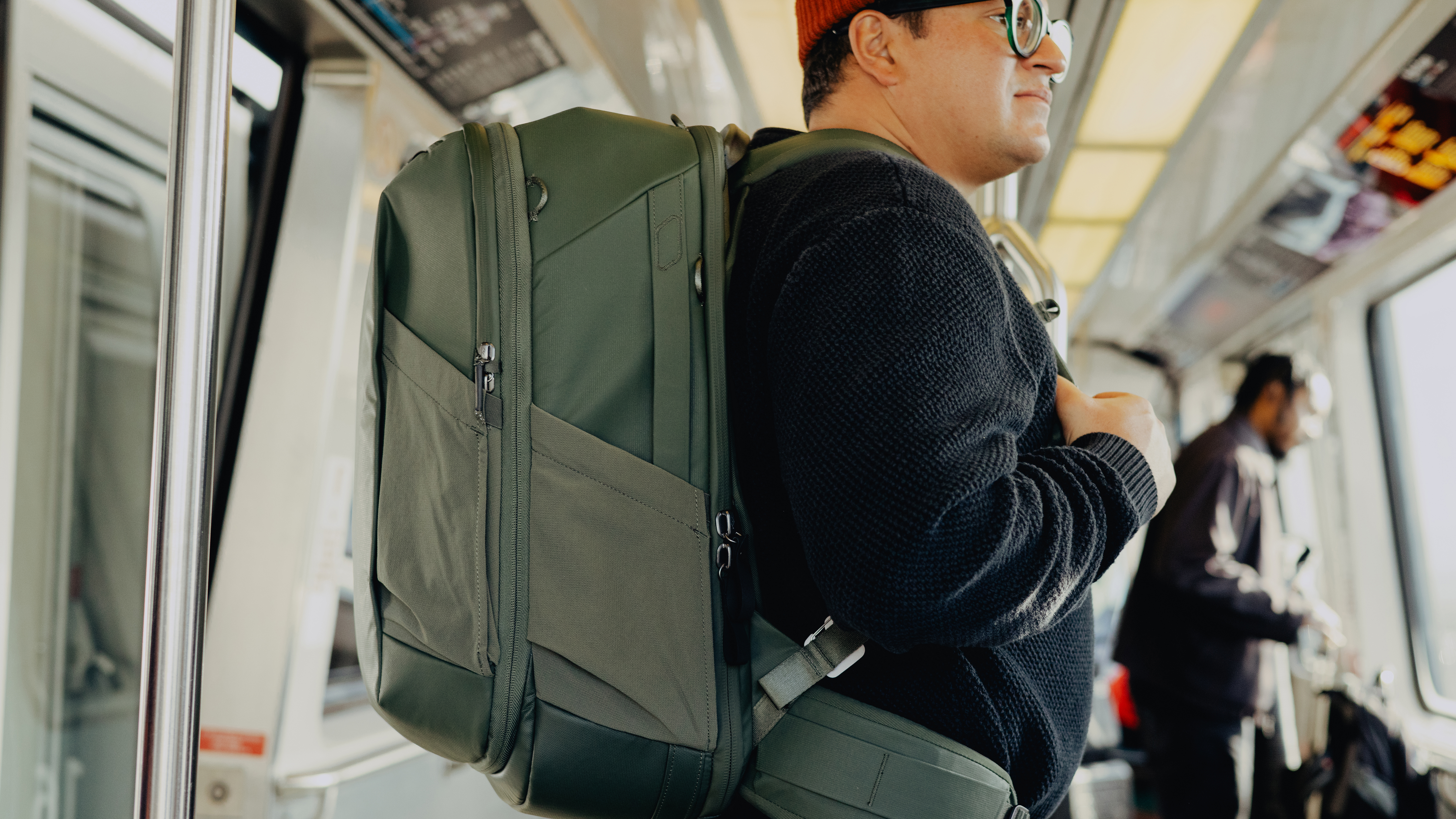 The Peak Design Travel 2-in-1 Backpack worn by a traveler