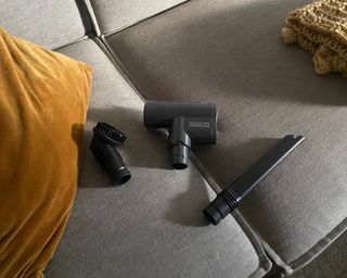 Proscenic P11 Smart vacuum's 3 attachments on grey sofa