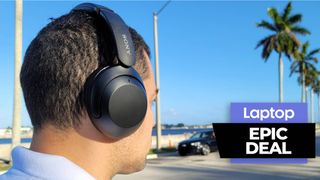 Man wearing wireless headphones outside with blue sky and palm trees in the background