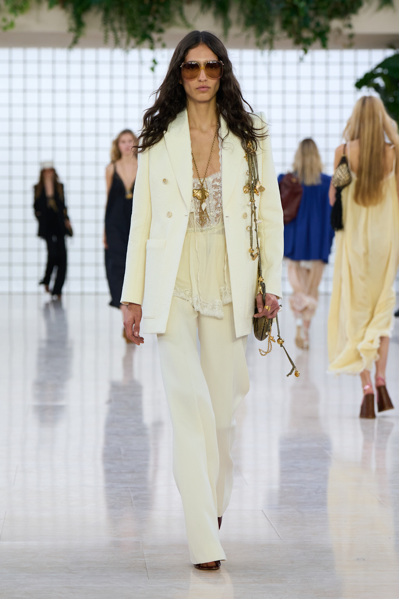 Model wears a boho blouse from the Chloe SS25 show.