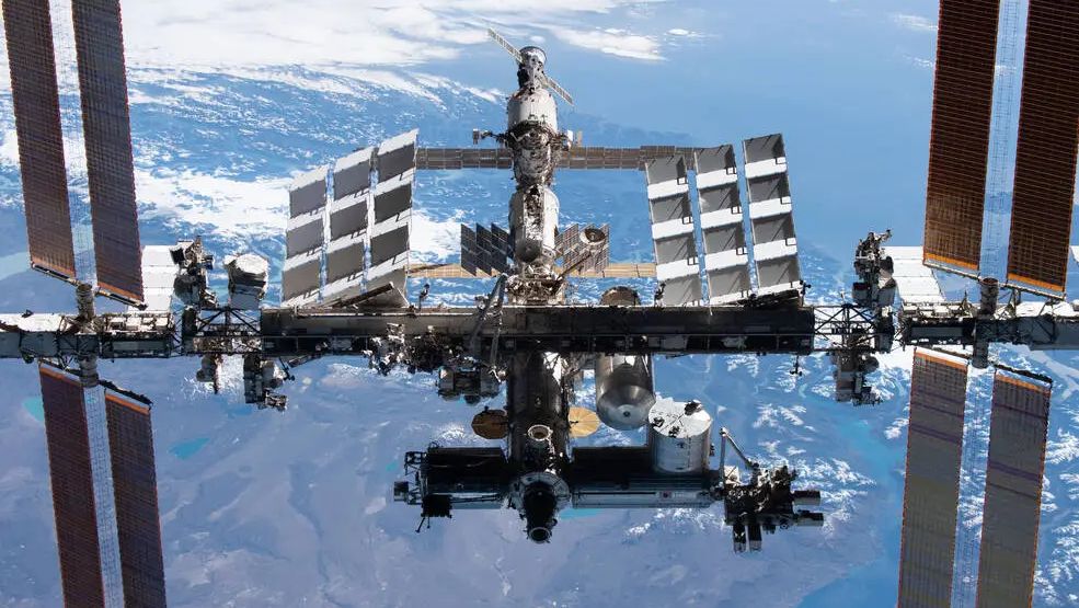 a view of the international space station, with earth seen below