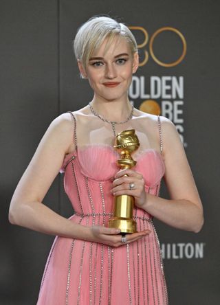 Julia Garner poses with the award for Best Supporting Actress - Television Series at the 2023 Golden Globe Awards