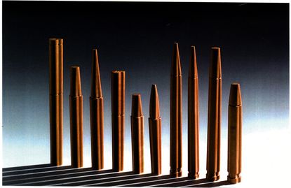 The original wooden prototypes of the pens designed by Achille Castiglioni and Gianfranco Cavaglià and made by Bottega Ghianda, found hidden behind a mirror in Castiglioni’s Milan studio. Different shaped wooden pens in a row with long shadows in front of them.