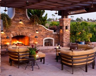 covered backyard patio with outdoor fireplace