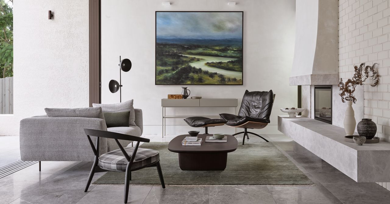 Grey living room with large artwork and fireplace