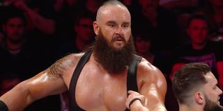 Braun Strowman looking at Finn Balor