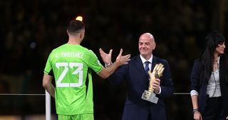 Emiliano Martinez of Argentina is presented the adidas Golden Glove by Gianni Infantino, President of FIFA, during the award ceremony following the FIFA World Cup Qatar 2022 Final match between Argentina and France at Lusail Stadium on December 18, 2022 in Lusail City, Qatar. 