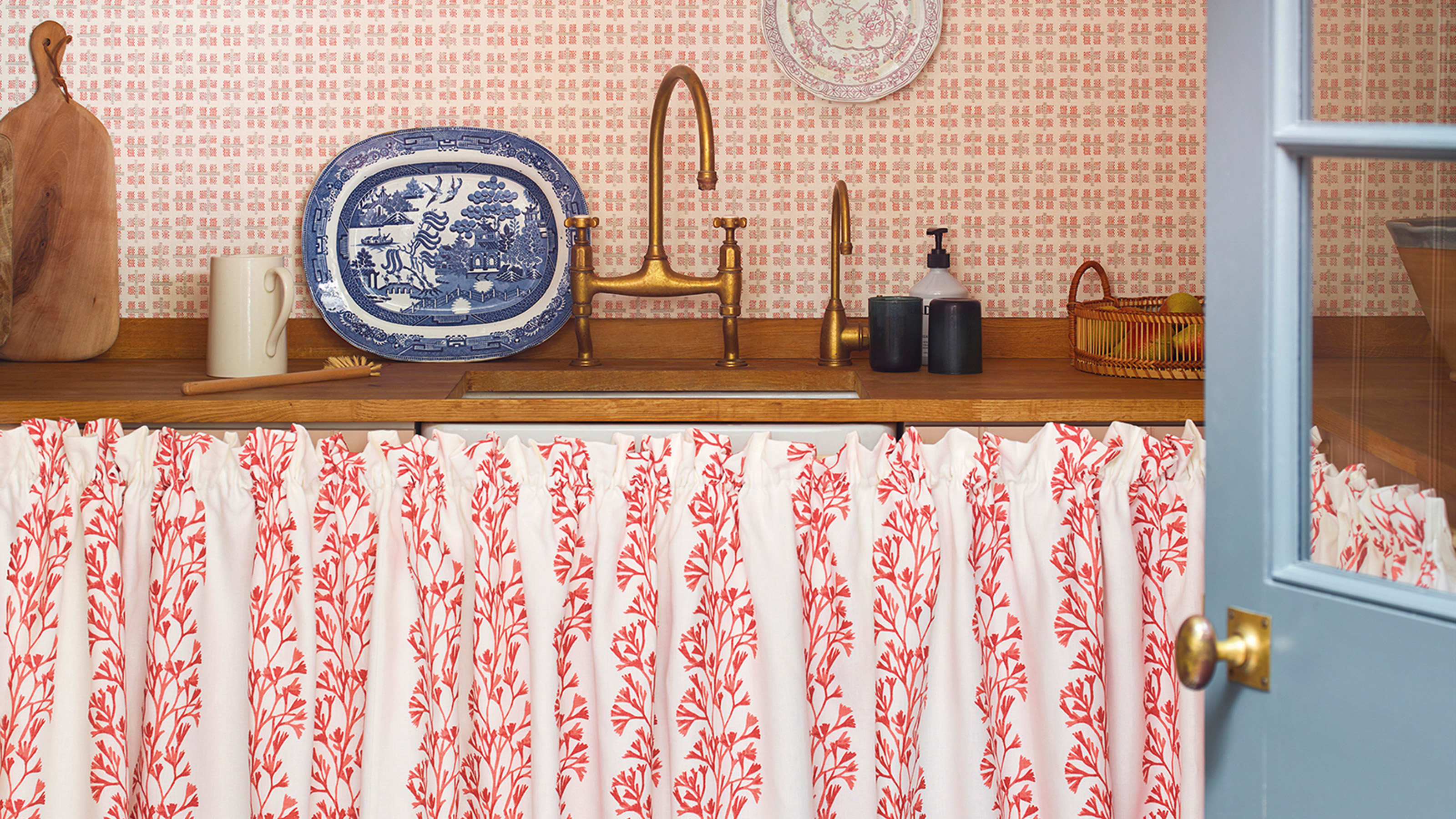 red and white sink skirt using jane Churchill fabric with wooden workop and brass taps