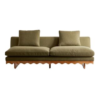 moss green sofa with two cushions and a scallop-edge frame