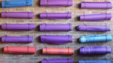 coloured yoga mats on a wall 